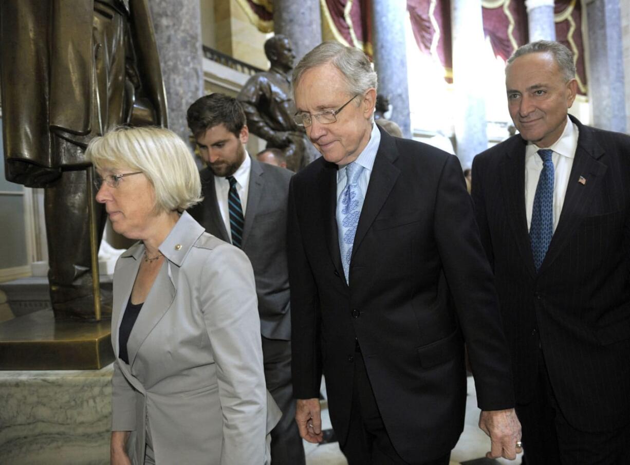 Senate Majority Leader Harry Reid of Nev., second from right, Sen. Charles Schumer, D-N.Y., right, Sen. Patty Murray, D-Wash., left, and Sen.