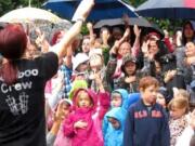 Cindy Wood leads children in their final vacation Bible school program at the Real Life Community Church, despite a rainstorm.