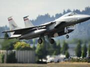 F-15 C model single seat jet fighters with the Oregon Air National Guard take off from Portland International Airport.