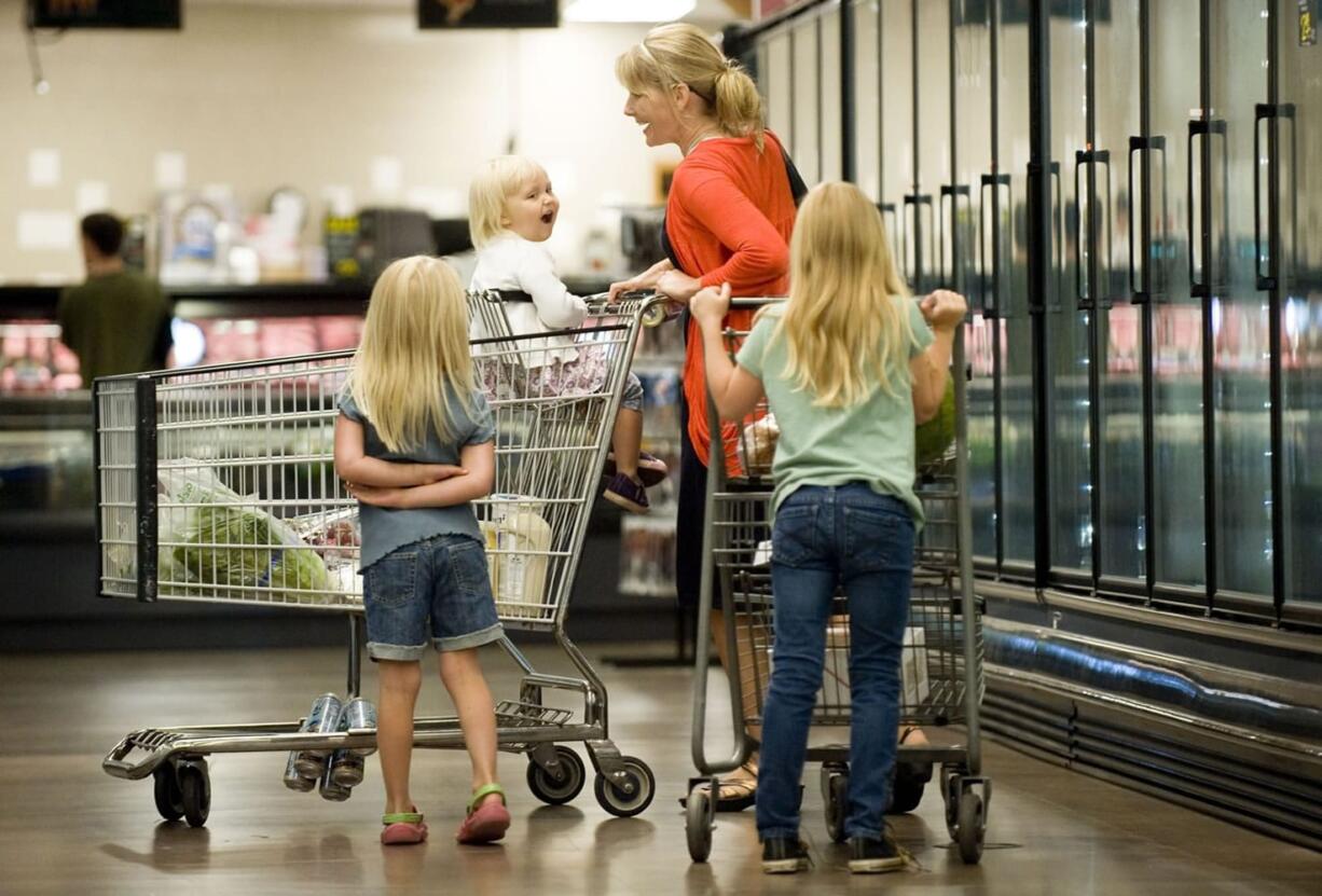 Connie Christopher, of Amboy, and her daughters, from left, Angeline, 5, Lindee, 2, and Noelle, 8, shop at Chuck's Produce on Tuesday in Vancouver.