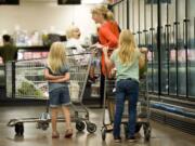 Connie Christopher, of Amboy, and her daughters, from left, Angeline, 5, Lindee, 2, and Noelle, 8, shop at Chuck's Produce on Tuesday in Vancouver.