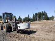 Construction on Luke Jensen Sports Park is under way, as a piece of the storm water drain system is moved into place.