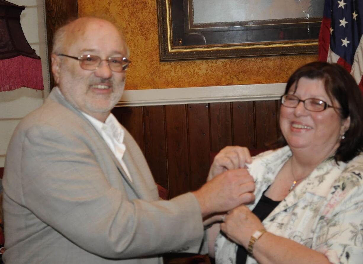 Outgoing Hazel Dell Lions President Jeff Fish, pins new President Carol Hansen.