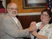 Outgoing Hazel Dell Lions President Jeff Fish, pins new President Carol Hansen.