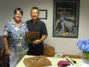 Robyn, left, and Sam Kim stand with the plaque presented to him for his 16 years on the Battle Ground school board.