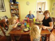 The Cowen family, clockwise from top center, Eric, Eileen, Marley, 3, Abraham, 4, and Bridget, 1, eat a dinner of red beans, tortillas and fresh vegetables at their Vancouver home.