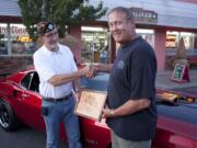 American Legion Post 44 commander Bruce Crockett, left, congratulates Gar March of Battle Ground on his best of show award at the Ridgefield Cruise-in.