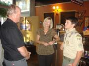 Paul Vernon, left, talks with Boy Scout Nathaniel Stafford, on right, and Nathaniel's grandmother Sharon Skinner, center.