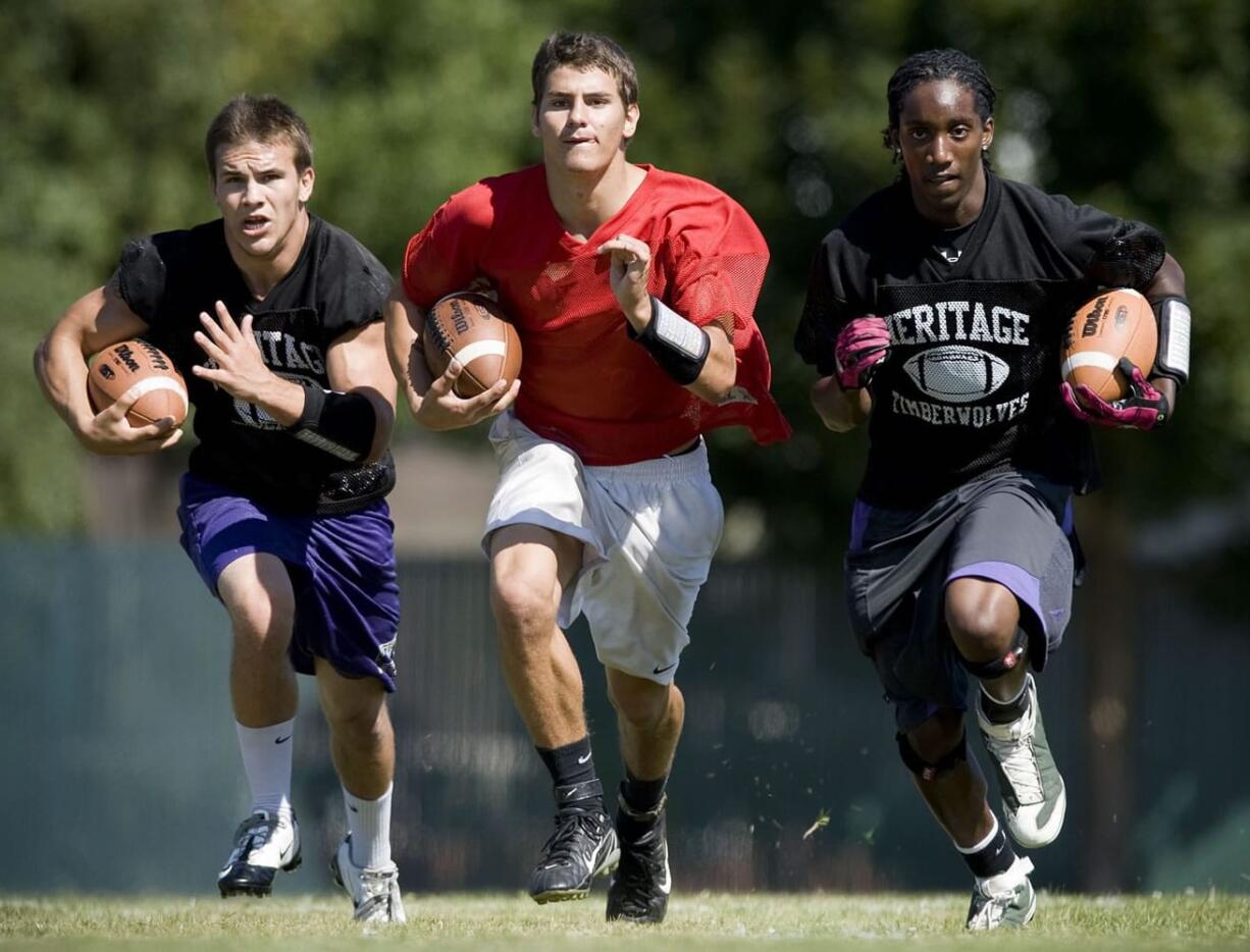 Heritage football players, from left, Gage Boyce, Joey Cooper and E'lon Mack make up a portion of the speedy Timberwolves football team.