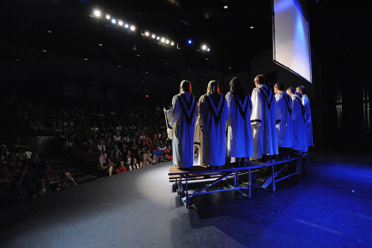 Washougal High School's chamber choir sings &quot;Set me as a seal&quot; during one of the school's two assemblies Friday morning. The program, with music, poetry and a video showing iconic images from Sept.