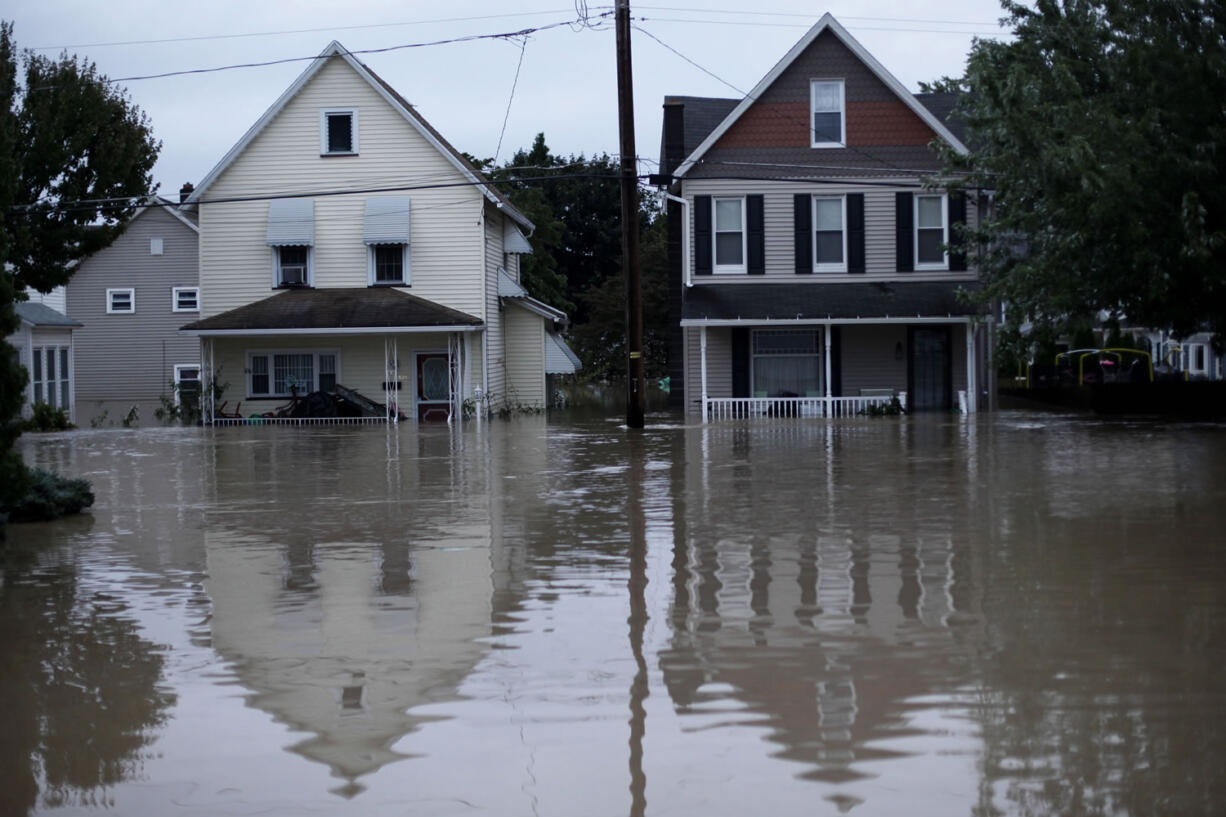 Floodwaters from the Susquehanna River partially submerge homes, Friday, Sept. 9, 2011, in West Pittston, Pa. Days of rainfall from what had been Tropical Storm Lee inundated a wide portion of Pennsylvania and other northeastern states Thursday, pouring into basements and low-lying homes and forcing tens of thousands of people to seek higher ground.