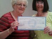 Yvonne Wright, left, of the Clark County Newcomers Club, presented a check for more than $4,000 to Mary Oldham of the Northwest Children's Outreach.