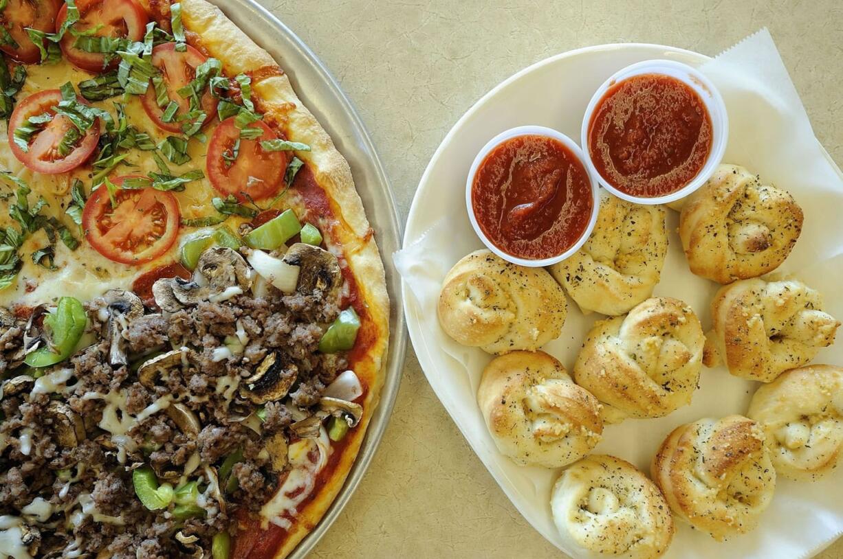 A large half Classic Combo and Classic Margherita pizza and garlic knots baked at N.Y.C.