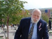 Floyd Rasmussen pauses at a memorial bench honoring his wife Rhonda Rasmussen, who was killed during the Sept.