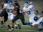 Camas High's Zach Marshall breaks free from Mountain View defenders during last week's game at Doc Harris Stadium.