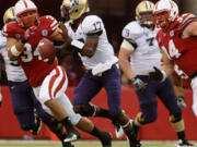 Washington quarterback Keith Price (17) is under pressure from Nebraska's Cameron Meredith (34) and Jared Crick (94) in the second half Saturday.