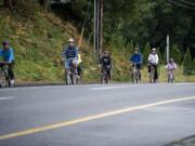 Participants in Saturday's Gordon Patterson Memorial Bike Ride head north on Northeast St.