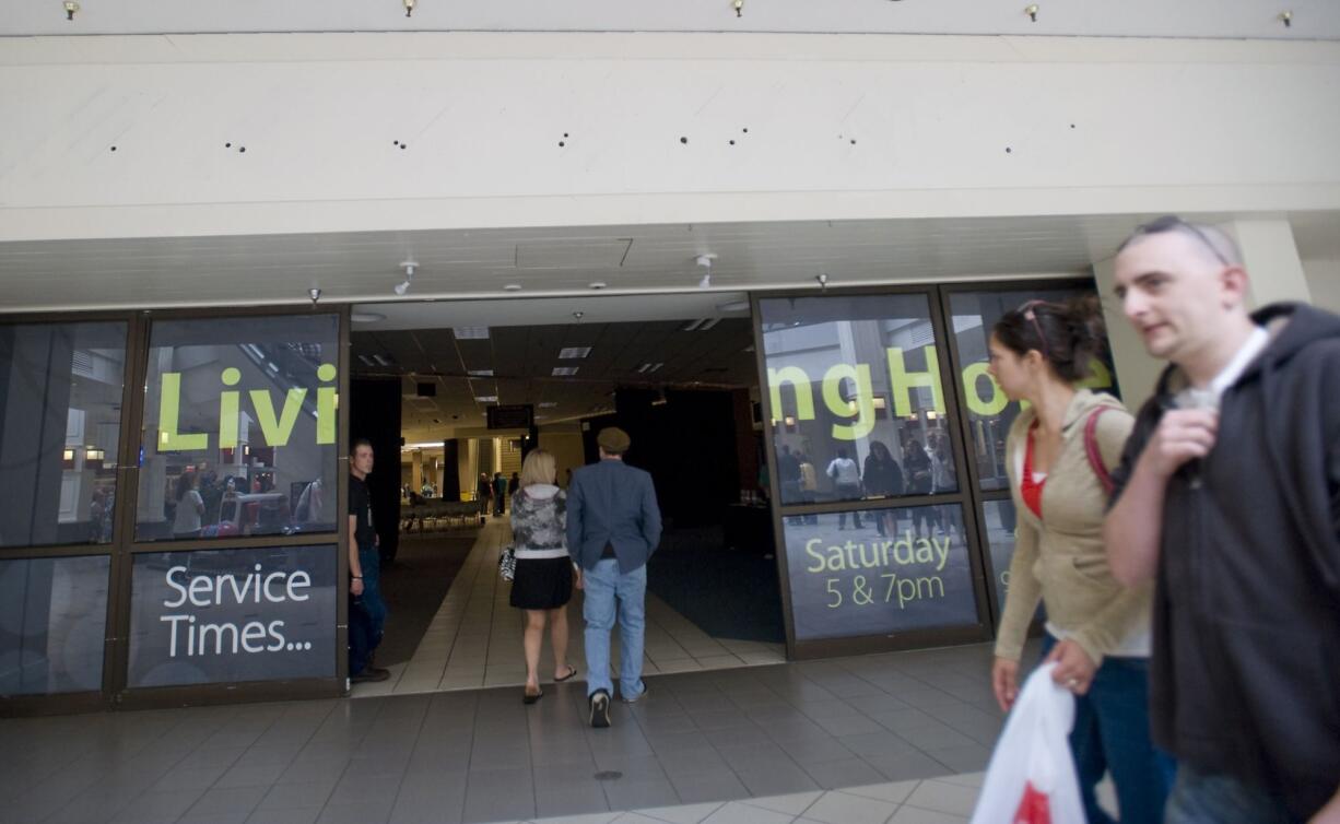 Patrons walk inside and past the Living Hope Church inside the Westfield Vancouver mall on Sunday May 23, 2010. Living Hope Church is struggling to meet the deadline to raise $5 million to buy the former Kmart building at 2711 N.E.