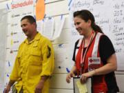 Fourth Plain Village: Dave LaFave, incident team commander and fire chief for Cowlitz 2 Fire and Rescue in Kelso, left, offered Kelly Anderson, director of Emergency Services for the Southwest Washington chapter of the American Red Cross, the Excellence in Service Award on Sept.