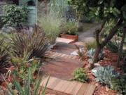 This walkway is made from scrap steel plates and remnant cedar planks from a fence.