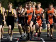 Battle Ground's Mark Tedder, center, leads his team out from the starting line during a recent cross country race at Hudson's Bay High.