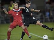 Abby Wambach battles with Canada's Carmelina Moscato in the first half at Jeld-Wen Field in Portland on Thursday.