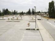 Jose Lopez, right, with Landscape Management and Services of Vancouver, hauls dirt at the new Salmon Creek Park &amp; Ride.