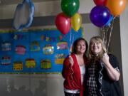 Emily Donaldson, left, and Karen Mallory hold balloons Friday at Meadowglade Seventh-day Adventist Church. The Battle Ground women, both cancer survivors, created the nonprofit, Celebrate Me Foundation.