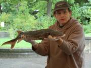 Olaf Langness, with Sturgeon and Smelt Projects for the Washington Department of Fish and Wildlife, gives a presentation during the 16th-annual Sturgeon Festival at the Water Resources Education Center.