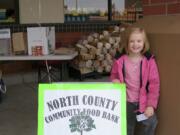 Elizabeth Rowe invites shoppers to donate food to the North County Community Food Bank uutside a Battle Ground grocery store