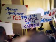 On this May 19, 2011 file photo, demonstrators on both sides of the gay marriage issue gathered outside the Minnesota House in St. Paul, Minn. The Census Bureau reports there are 131,729 same-sex couples in the U.S. who say they're married _ the first-ever government count of this kind.