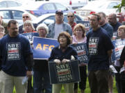 Juanita Greenway, a private citizen, questions a speaker at a rally outside Rep. Jaime Herrera Beutler's office in Vancouver.