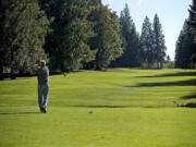 Jerry Anderson of Vancouver drives the ball off the 18th tee Wednesday at The Cedars on Salmon Creek golf course in Brush Prairie.