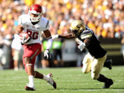 Washington State's Marquess Wilson runs the ball past Colorado's Brian Lockridge.