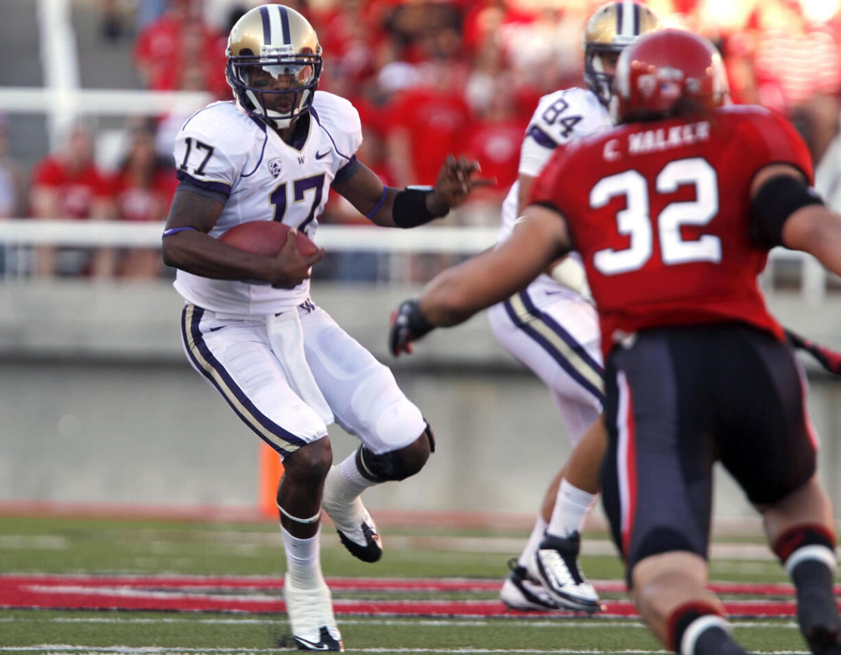 Washington quarterback Keith Price (17) attempts to evade Utah linebacker Chaz Walker (32).