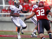 Washington quarterback Keith Price (17) attempts to evade Utah linebacker Chaz Walker (32).