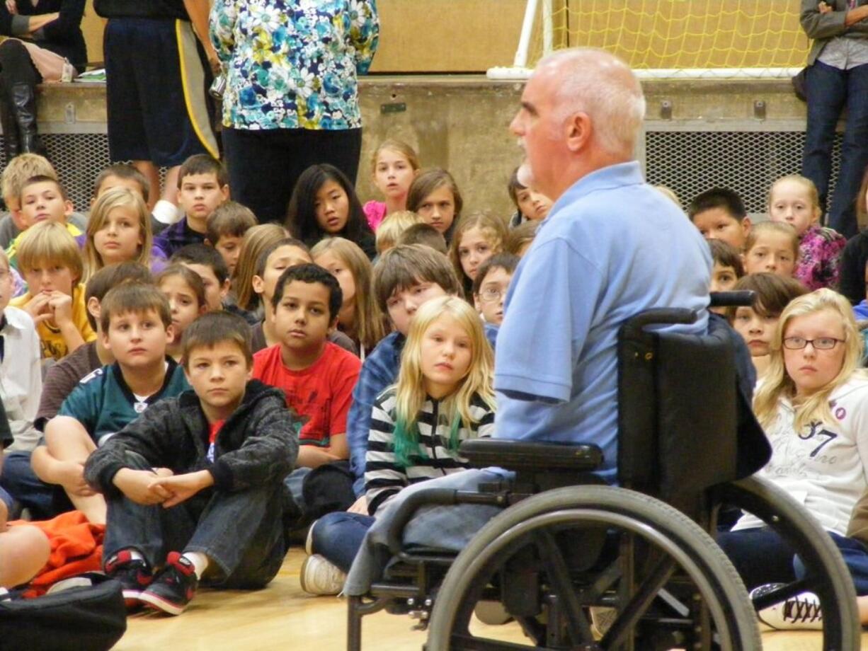 After losing both legs and one arm in an auto accident, Bob Mortimer shares his story with students at Maple Grove Middle School.