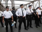 Police turn to face the front line of protesters Saturday who walked behind them about one third of the way onto New York's Brooklyn Bridge before police began making arrests during Saturday's march by Occupy Wall Street. Protesters speaking out against corporate greed and other grievances attempted to walk over the bridge from Manhattan, resulting in the arrest of more than 700 during a tense confrontation with police.