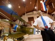 Laureano Mier, Pearson Air Museum manager, stands in front of a replica Fokker triplane that will be one of two on display Saturday during a special program on World War I.