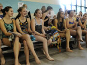 Shelby Kappler, third from left, sits with her Skyview High School teammates before swim practice at the Propstra Aquatic Center.