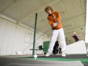 Lucas Minter, from Vancouver, hits a bucket of balls at Vanco Golf and Driving Range.