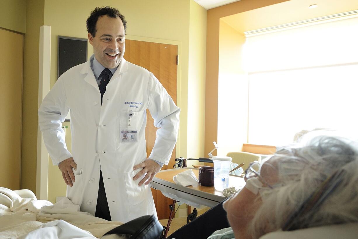 Dr. John Dempster checks on Jeanne Hillier, 73, of Vancouver at Legacy Salmon Creek Medical Center.