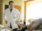 Dr. John Dempster checks on Jeanne Hillier, 73, of Vancouver at Legacy Salmon Creek Medical Center.