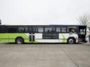 Passengers wait to board a C-Tran bus at the Vancouver Mall Transit Center in April.