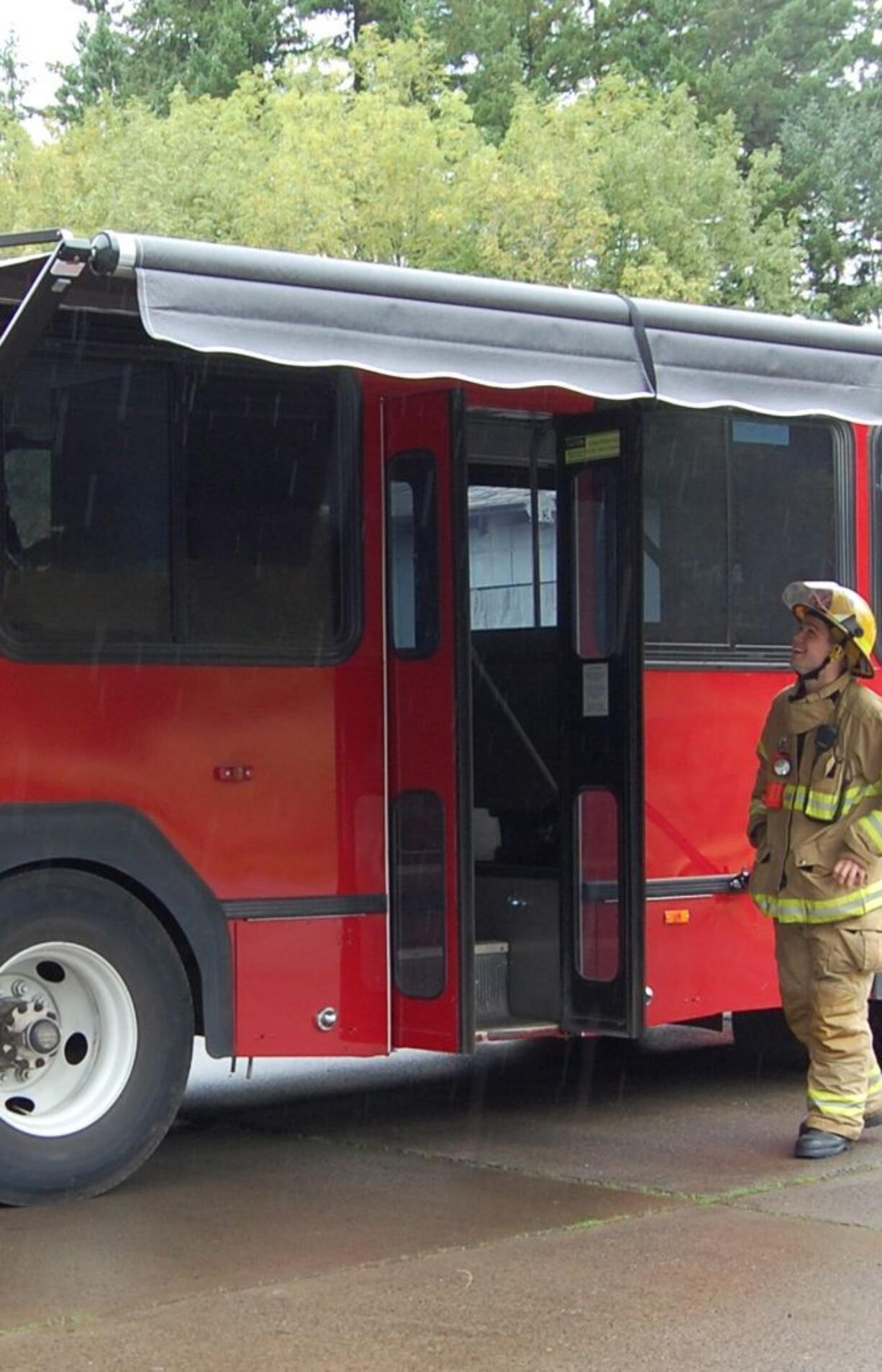 Firefighter Garrett Riley inspects the new canopy on the Clark County Fire &amp; Rescue rehabilitation bus.