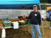 Ridgefield: Master Gardener Burke Harris shows off produce from Northwest Organic Farms during the 2011 Clark County Harvest Celebration Farm Tour.