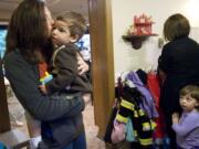 Sarah Remington gives her son, Jacob, 2, a kiss while dropping him off at Wendy's Teddy Bear Day Care in Vancouver last week.