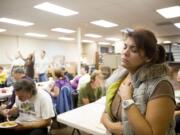 Analisa Clymer of Vancouver closes her eyes in prayer during singles night activities Thursday at the Clark County Christian Center in Vancouver. Top: Annette North, center, had a vision to start Clark County Christian Center 12 years ago after enduring a divorce and the death of her father. The center formally opened Sept.