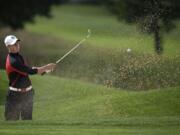 Union's Alistair Docherty hits out of the bunker on the 18th hole during the final round of the Class 4A district golf tournament Wednesday at Tri-Mountain Golf Course in Ridgefield.