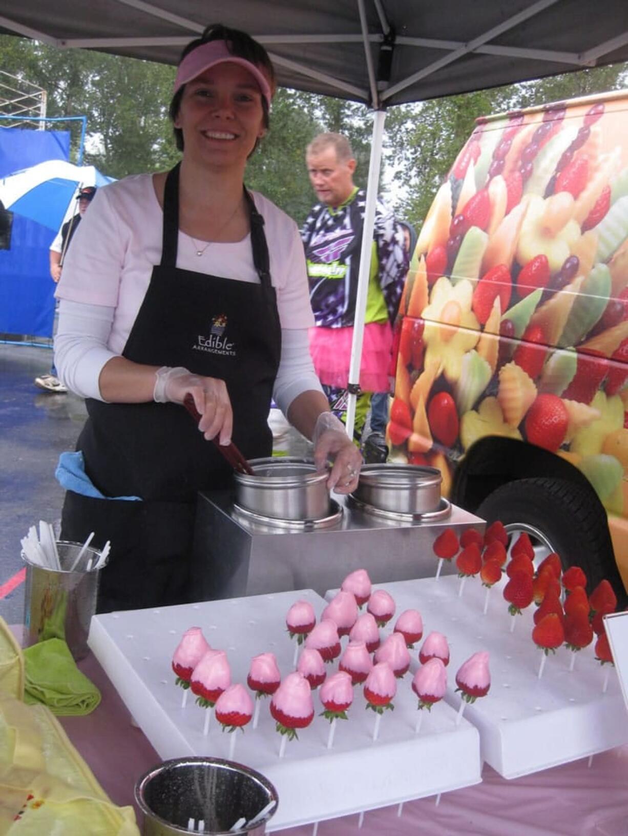 Washougal: Lisa and Chris Schloe of Edible Arrangements dipped strawberries in pink chocolate all night to support the Motocross Race for a Cure.